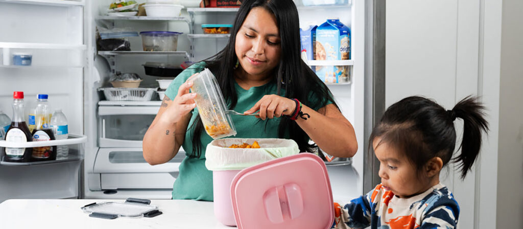 Parent and child in kitchen preparing food
